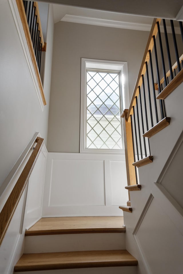 stairway featuring ornamental molding