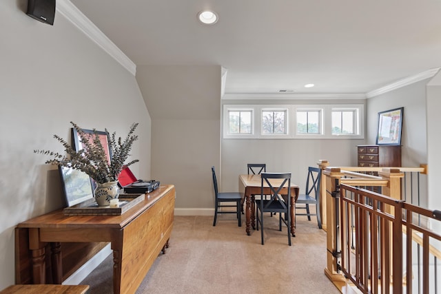 carpeted dining room with ornamental molding