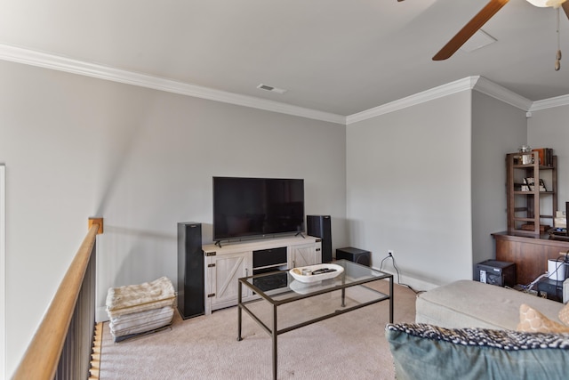 carpeted living room featuring ceiling fan and ornamental molding