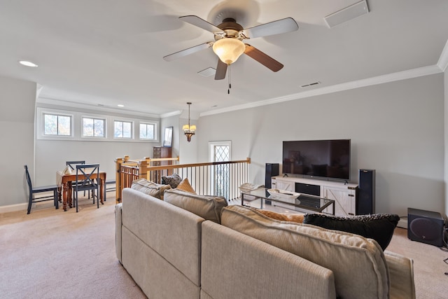 living room featuring ceiling fan, ornamental molding, and light carpet