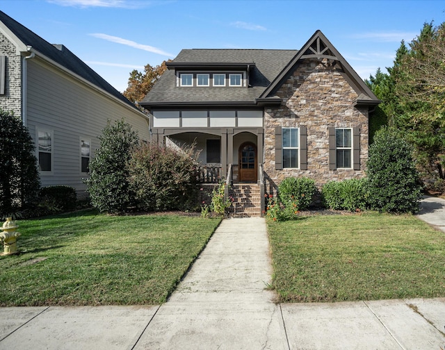 view of front facade featuring a front lawn and covered porch