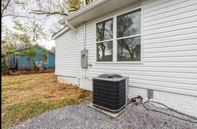 view of side of home with central AC unit