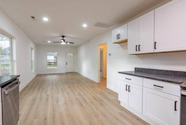 kitchen with white cabinets, ceiling fan, a healthy amount of sunlight, and stainless steel dishwasher