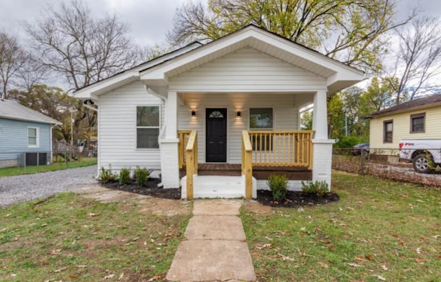 bungalow-style house with a porch and a front lawn