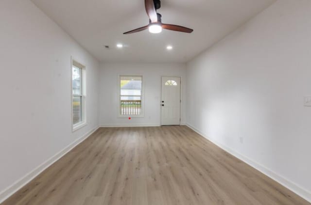 interior space with light hardwood / wood-style floors and ceiling fan