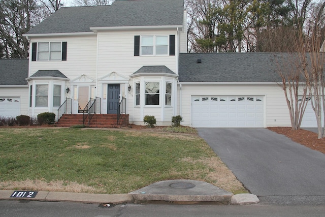 view of front of home featuring a front yard and a garage