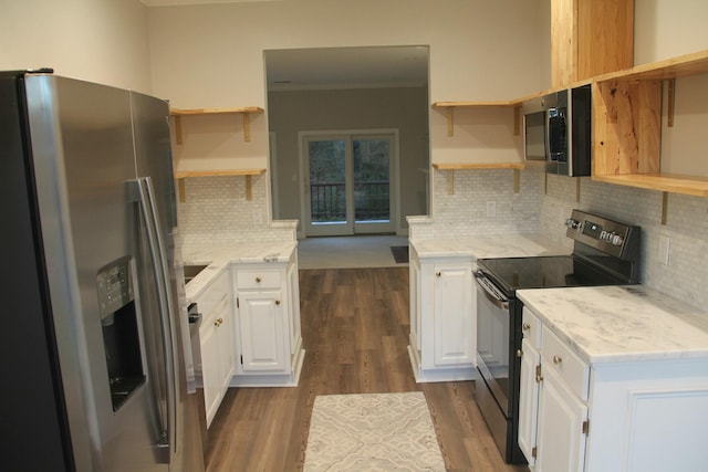 kitchen featuring dark wood-type flooring, appliances with stainless steel finishes, backsplash, and white cabinetry