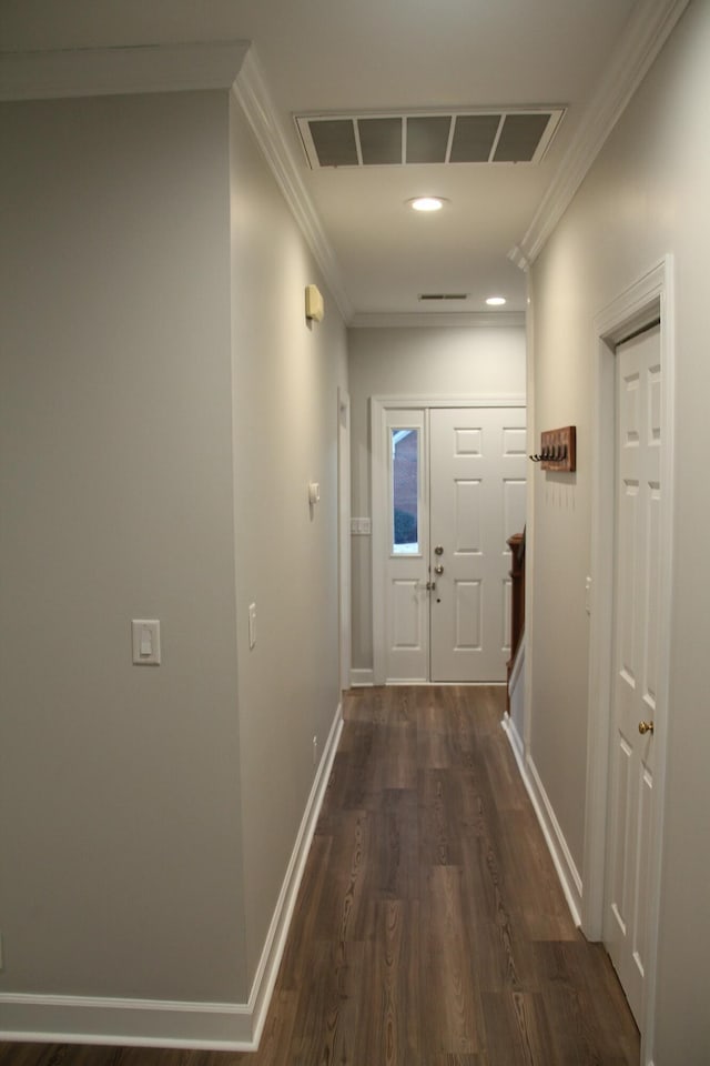 hall featuring dark wood-type flooring and ornamental molding