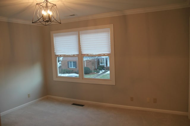 carpeted empty room with an inviting chandelier and ornamental molding