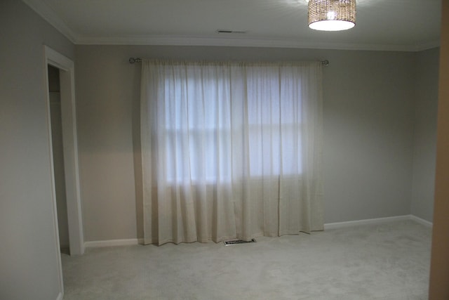 carpeted spare room with ornamental molding