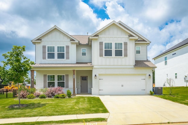 craftsman-style house with central air condition unit, a front lawn, and a garage