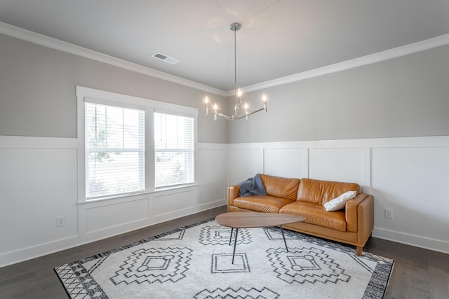 living room with a notable chandelier, dark wood-type flooring, and crown molding