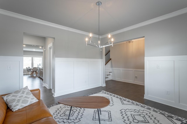 dining space featuring dark hardwood / wood-style flooring, crown molding, and a notable chandelier