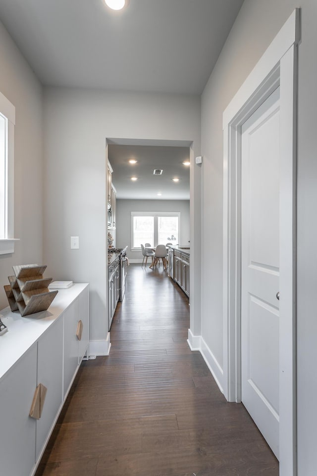 hallway with dark hardwood / wood-style floors