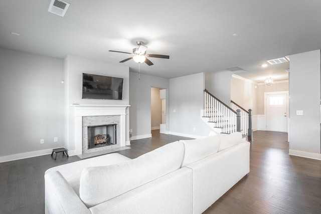 living room with ornamental molding, ceiling fan, and dark hardwood / wood-style floors