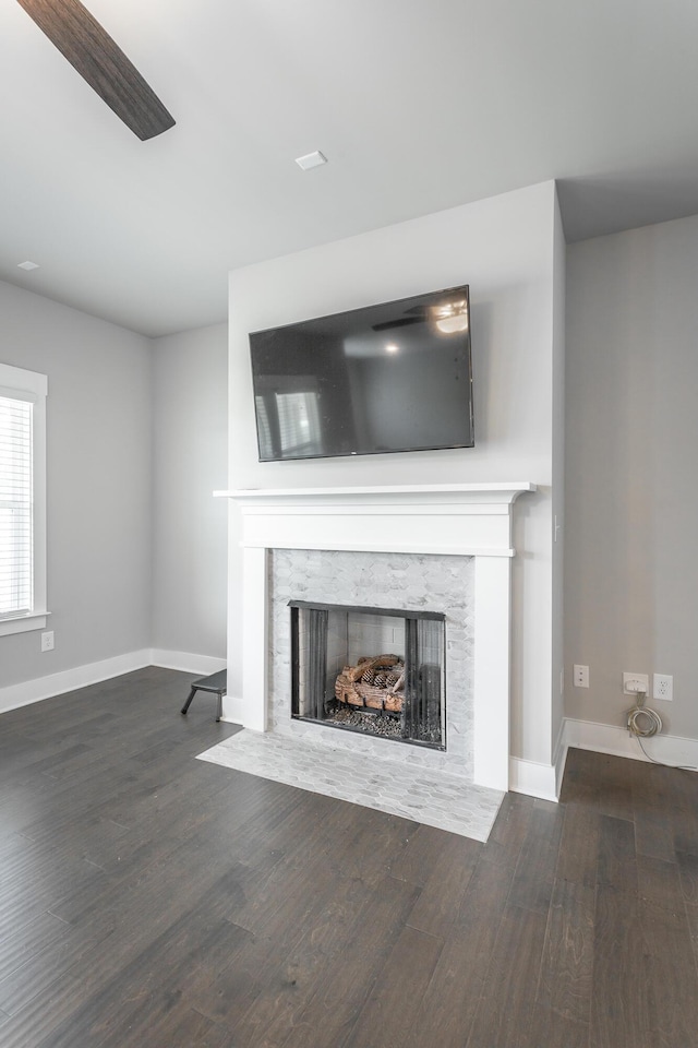 unfurnished living room with a high end fireplace and dark hardwood / wood-style flooring