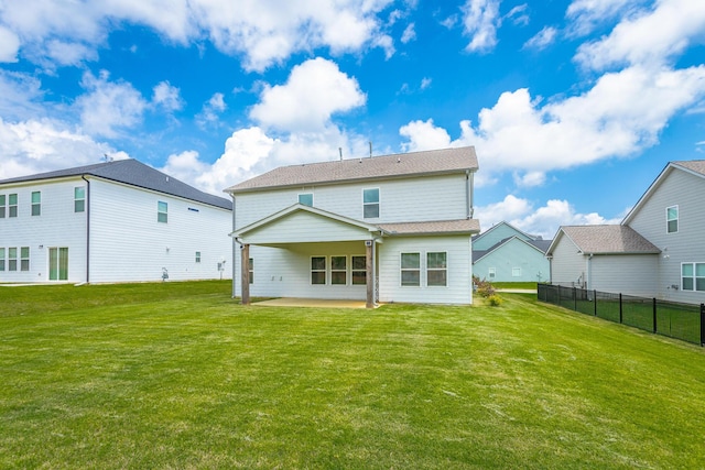 rear view of property featuring a patio and a yard