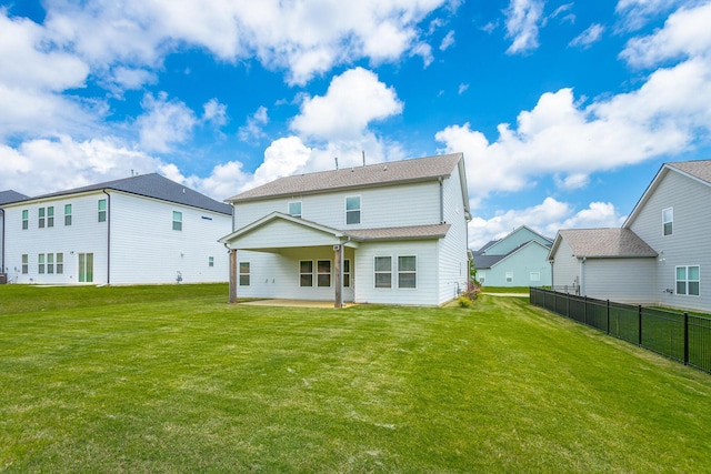 back of property featuring a patio and a yard