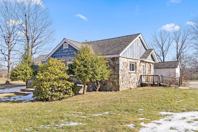 view of home's exterior with a wooden deck and a yard