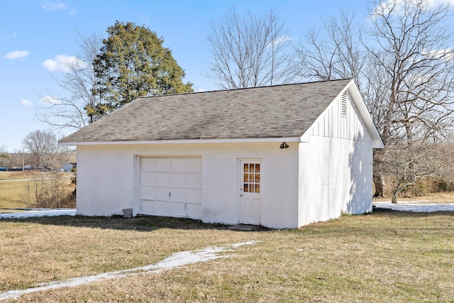 garage featuring a lawn