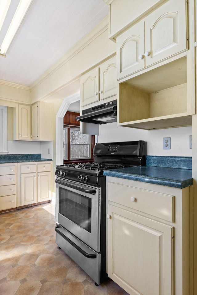 kitchen with stainless steel gas stove, crown molding, and cream cabinets