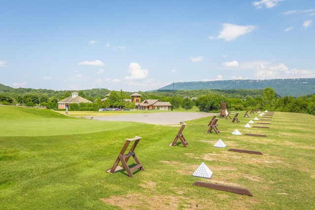 view of property's community with a lawn and a mountain view