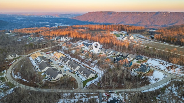 snowy aerial view with a mountain view