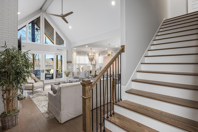 living room featuring hardwood / wood-style flooring, ceiling fan, stairs, high vaulted ceiling, and recessed lighting