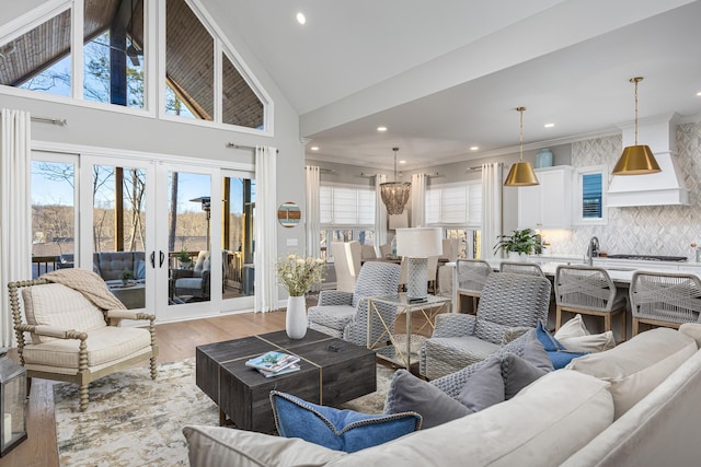 living area featuring high vaulted ceiling, recessed lighting, french doors, and wood finished floors