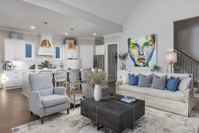 living area with ornamental molding, wood finished floors, and recessed lighting