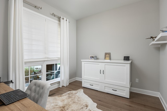 office area with dark wood-style flooring and baseboards