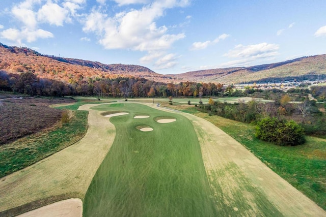 view of home's community featuring view of golf course and a mountain view