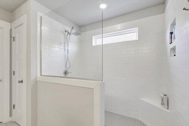 bathroom featuring tiled shower