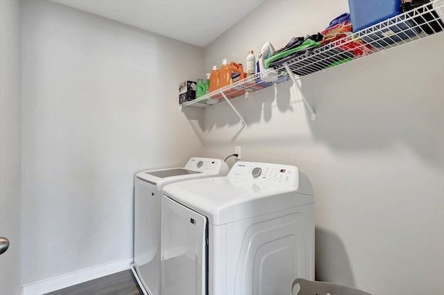 clothes washing area featuring dark hardwood / wood-style flooring and independent washer and dryer