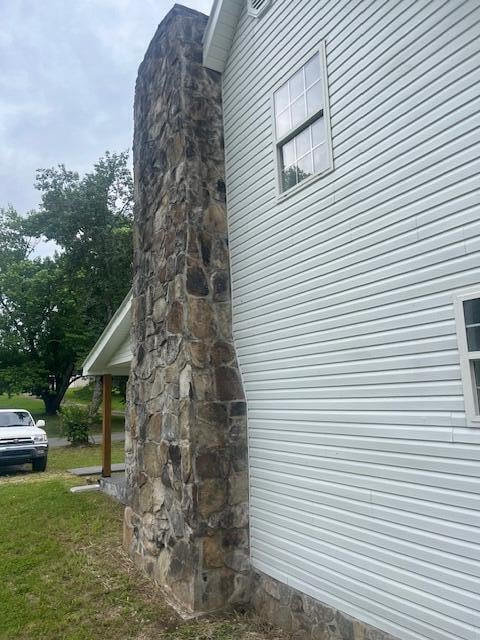 view of property exterior featuring a lawn