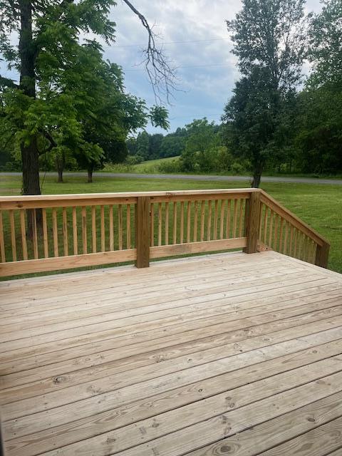 wooden deck with a yard