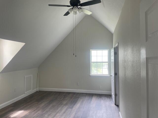 bonus room featuring ceiling fan, dark wood-type flooring, and lofted ceiling