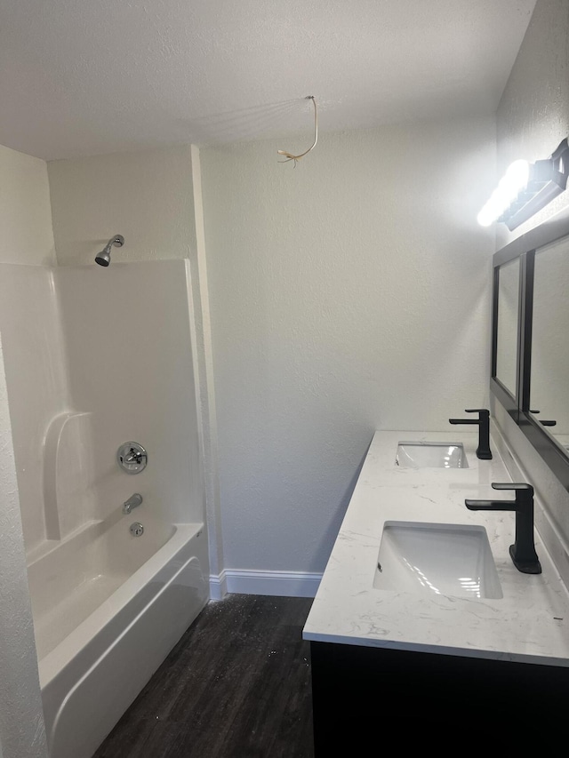 bathroom featuring hardwood / wood-style floors,  shower combination, and vanity