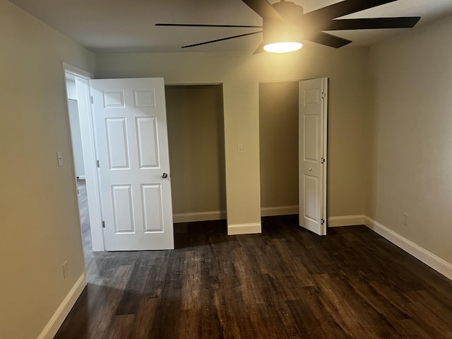 unfurnished bedroom featuring ceiling fan and dark hardwood / wood-style floors