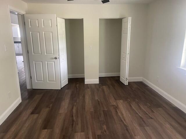 unfurnished bedroom featuring dark hardwood / wood-style floors