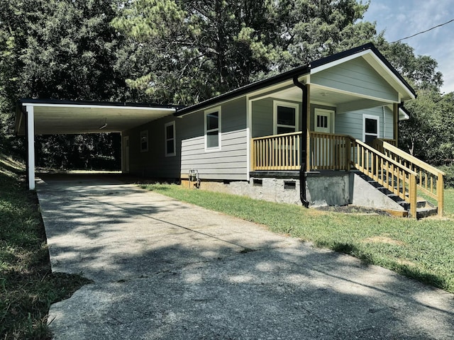 view of front facade featuring covered porch and a carport