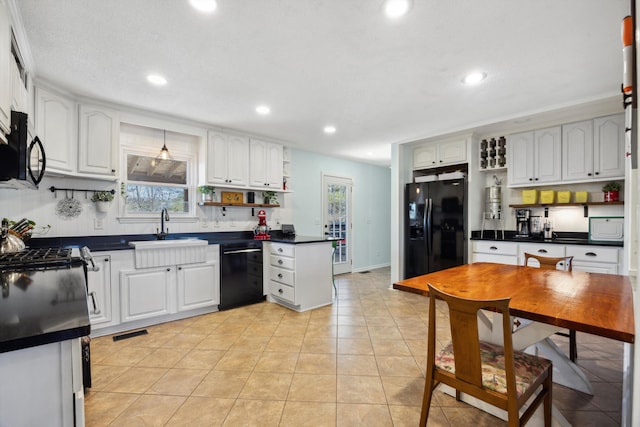 kitchen featuring black appliances, light tile patterned floors, sink, white cabinetry, and tasteful backsplash