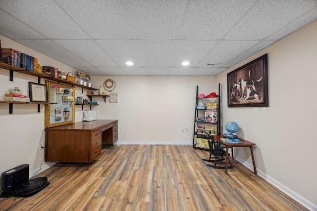 office area with hardwood / wood-style flooring and a drop ceiling