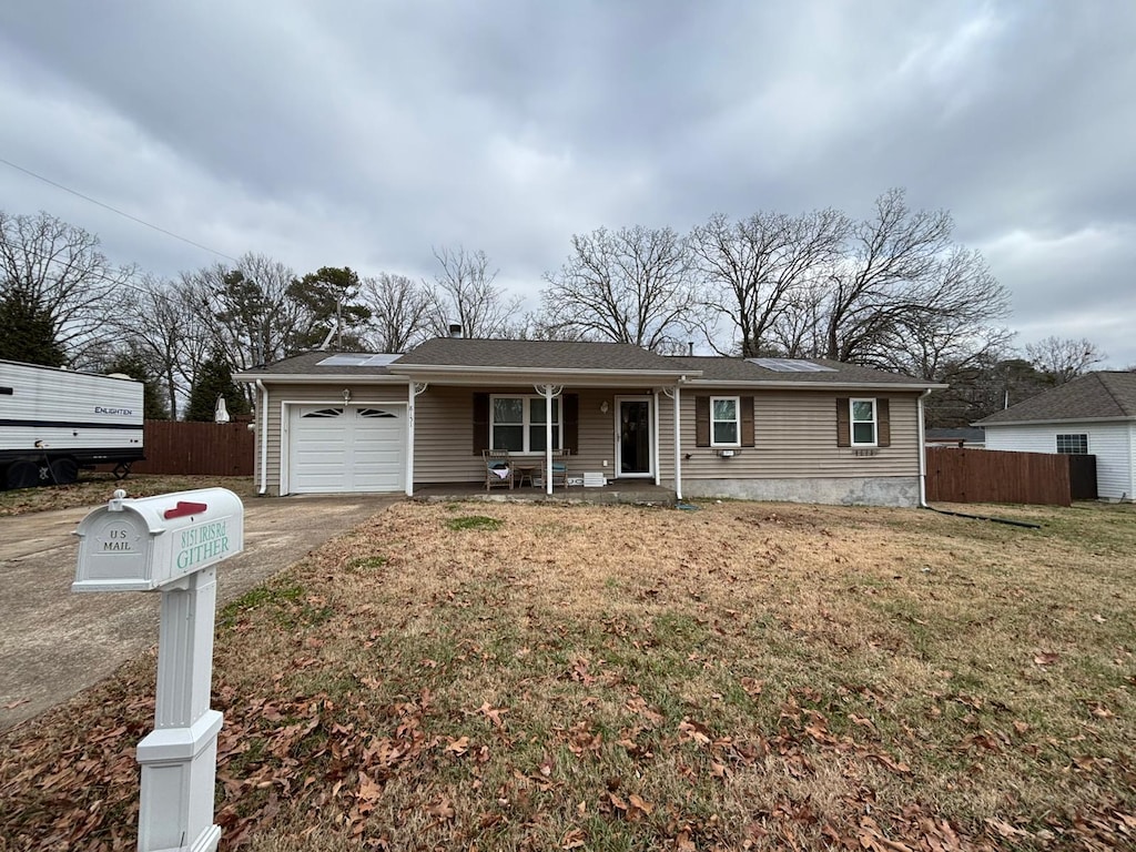 single story home with a front lawn and a garage