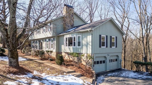 snow covered property featuring a garage