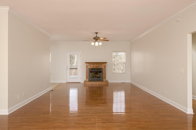 unfurnished living room with ceiling fan, ornamental molding, and dark hardwood / wood-style floors