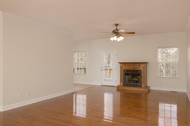 unfurnished living room with ceiling fan, ornamental molding, and wood-type flooring