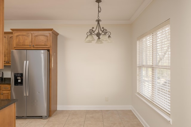 kitchen with a chandelier, light tile patterned floors, hanging light fixtures, and stainless steel fridge