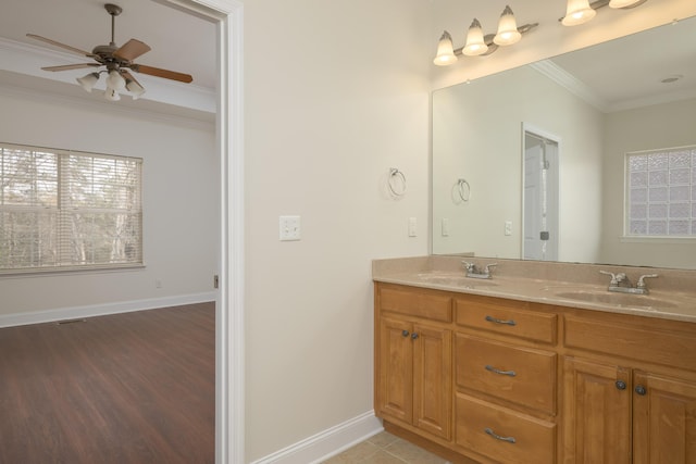 bathroom featuring ceiling fan, crown molding, and vanity