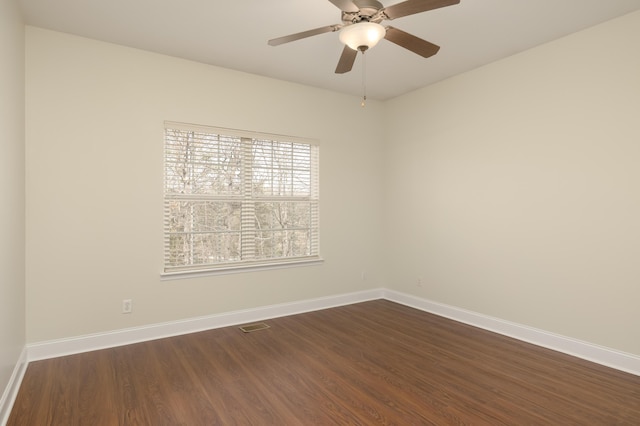 unfurnished room featuring ceiling fan and dark wood-type flooring